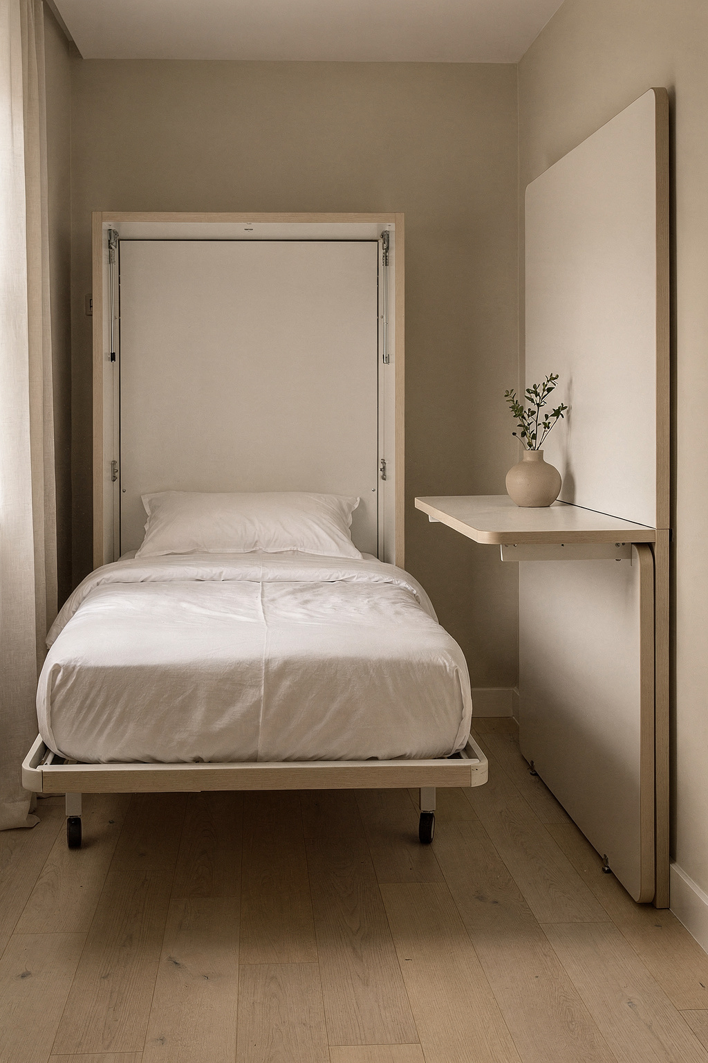 Schmales Zimmer mit ausgeklapptem Gästebett und zusammengeklapptem Schreibtisch an der Wand, platzsparend eingerichtet.